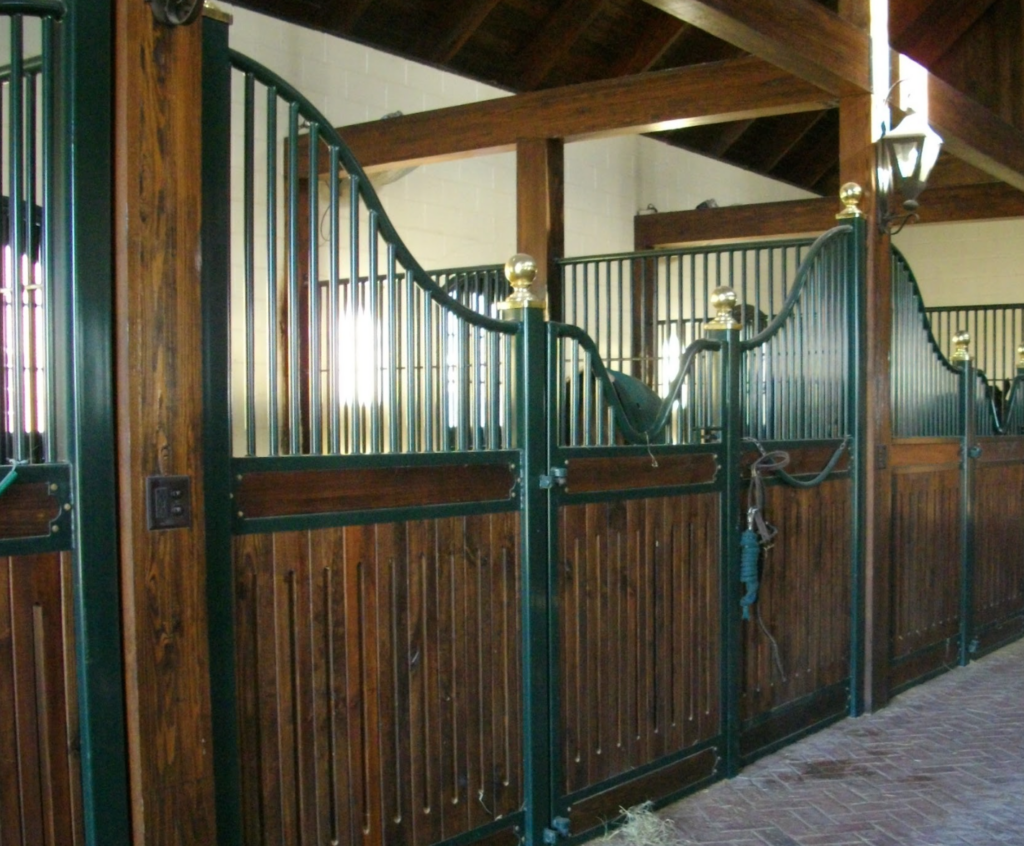 Interior of Le Bocage barn with elegant stalls and warm wood detailing